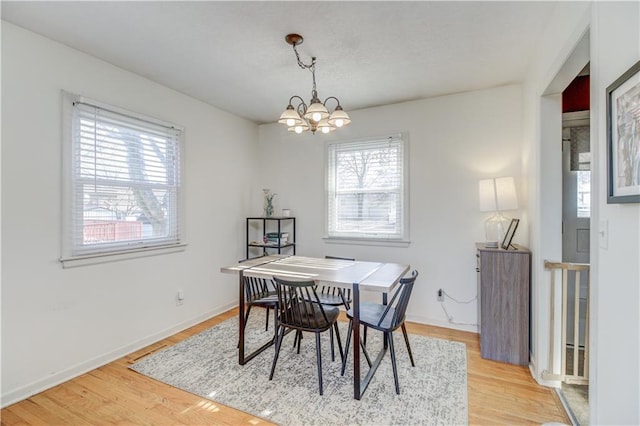 dining space featuring a chandelier, hardwood / wood-style flooring, and a wealth of natural light