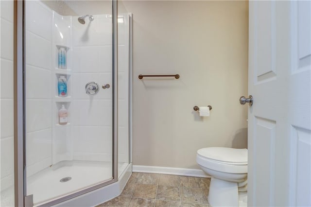 bathroom featuring toilet and an enclosed shower