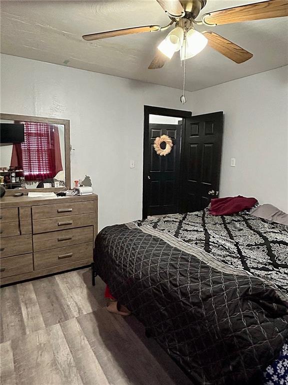 bedroom with ceiling fan and light hardwood / wood-style flooring