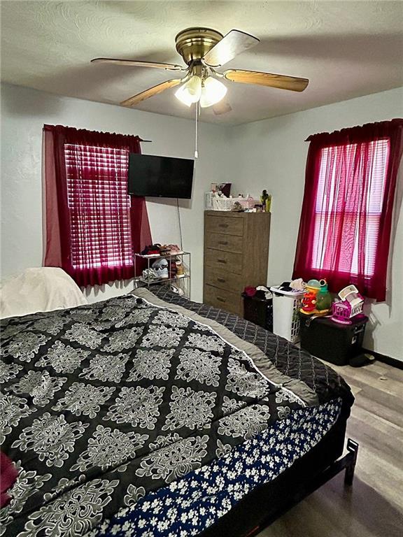 bedroom with a textured ceiling and ceiling fan