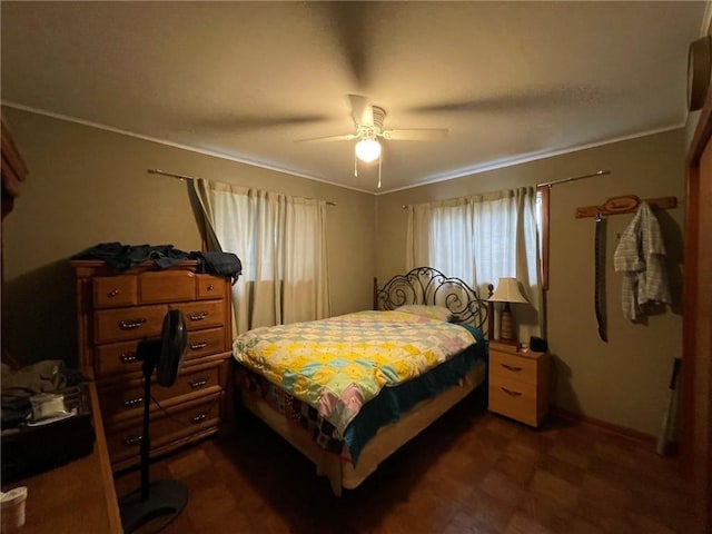 bedroom featuring ceiling fan and crown molding