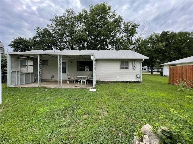 rear view of property with a patio area and a yard