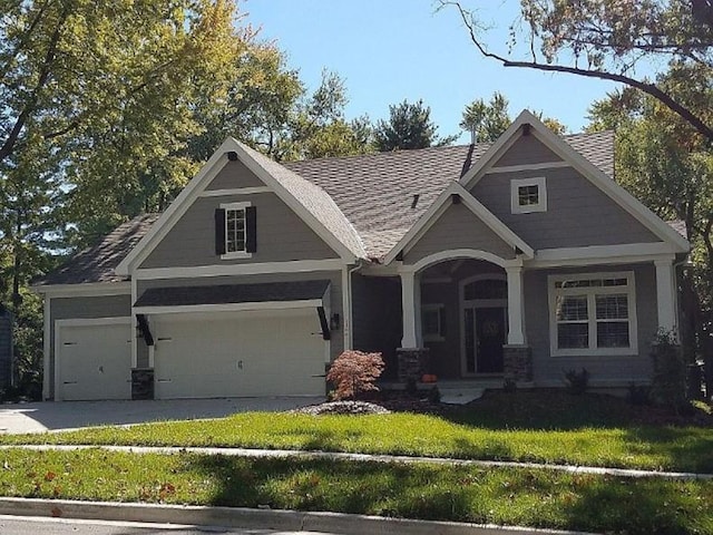 craftsman-style house with a garage and a front yard