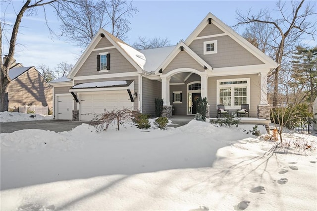 craftsman house featuring a porch and a garage