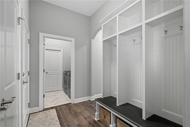 mudroom with wood-type flooring and washer and dryer