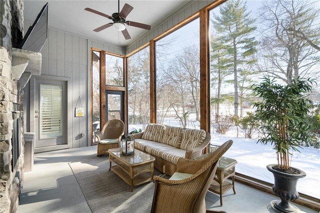 sunroom / solarium featuring ceiling fan and a healthy amount of sunlight