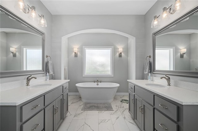 bathroom with a bath and vanity