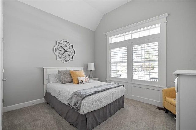 bedroom featuring lofted ceiling and carpet flooring