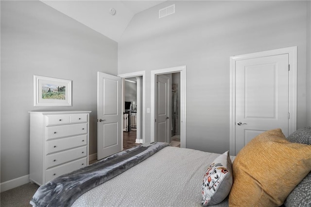 carpeted bedroom with vaulted ceiling