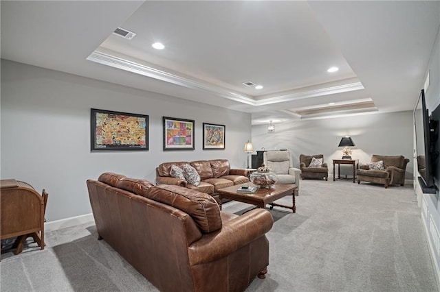 carpeted living room featuring a tray ceiling