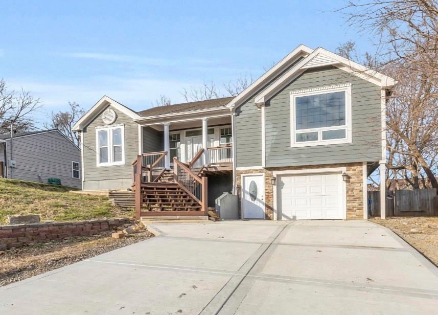 view of front of home featuring a porch and a garage