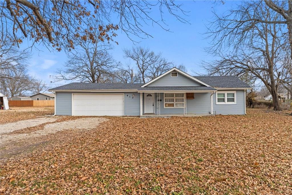 single story home with covered porch and a garage