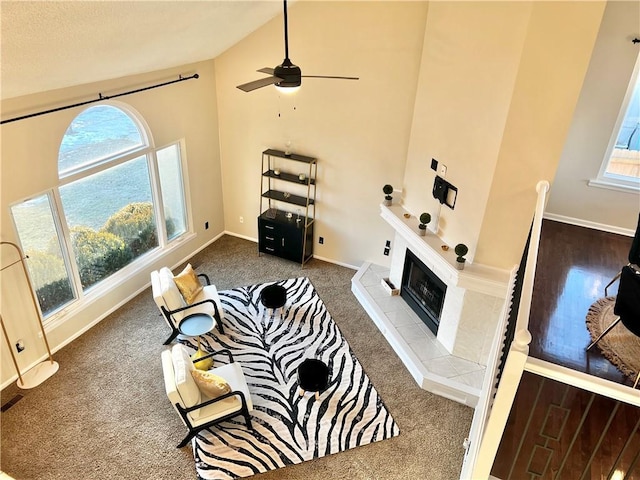 carpeted living room featuring vaulted ceiling and a fireplace