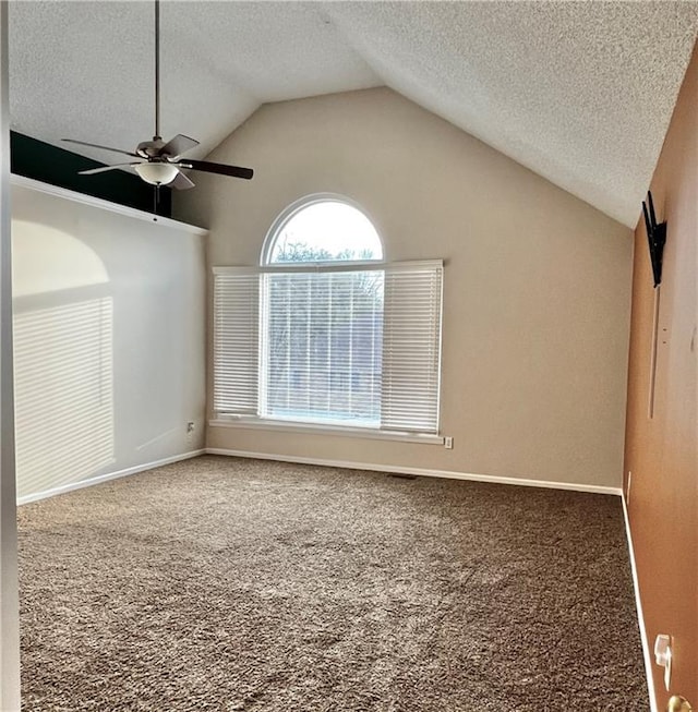 carpeted spare room featuring ceiling fan, lofted ceiling, and a textured ceiling