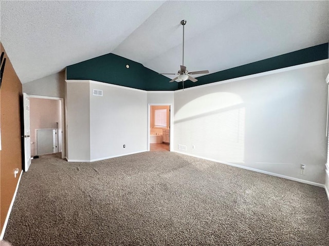 carpeted empty room featuring vaulted ceiling, a textured ceiling, and ceiling fan