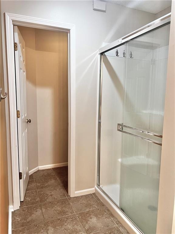 bathroom with a shower with shower door