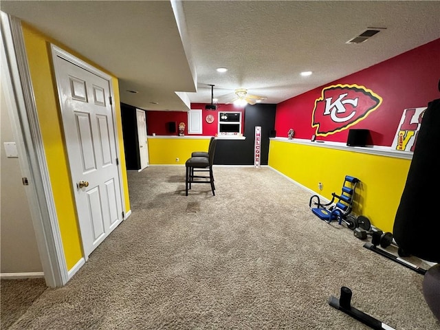 interior space with a textured ceiling and carpet