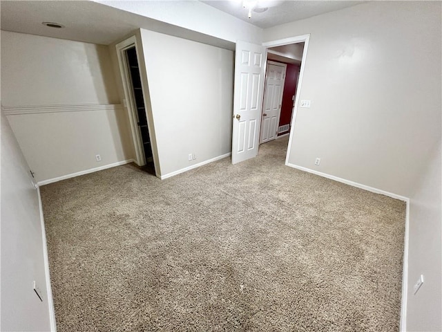 unfurnished bedroom featuring carpet floors and a closet