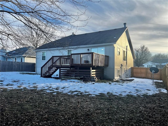 snow covered property featuring a wooden deck