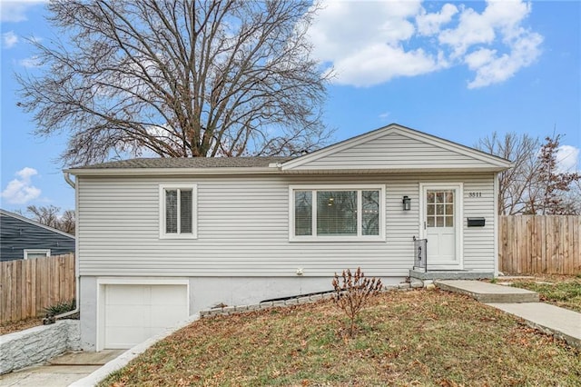 view of front of property featuring a garage and a front lawn