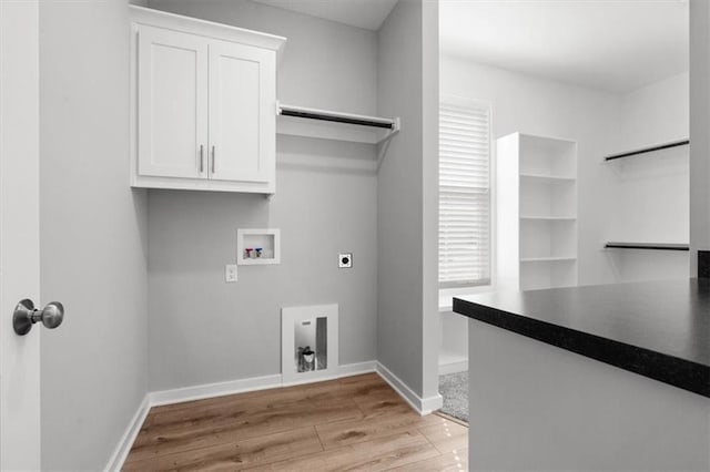 laundry room featuring cabinets, hookup for an electric dryer, hookup for a washing machine, and light hardwood / wood-style floors