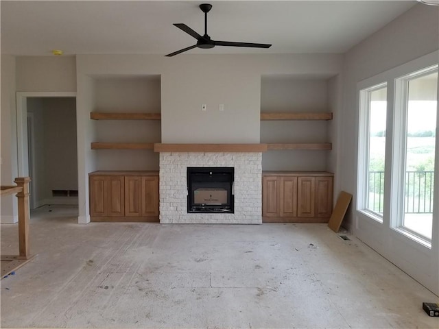 5005 146th St, Basehor, KS 66007 - unfurnished living room featuring a fireplace and ceiling fan