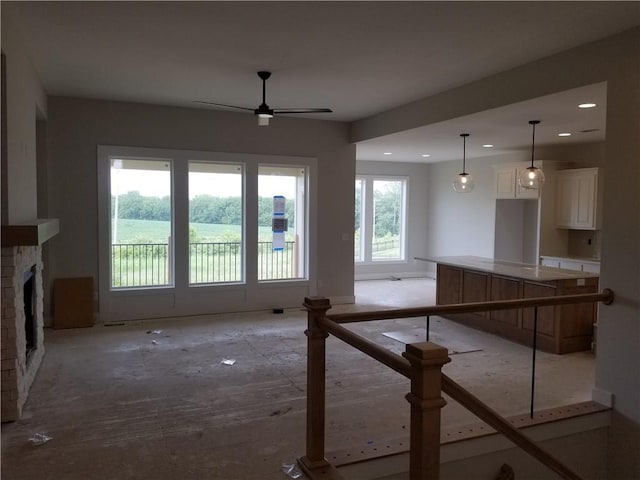5005 146th St, Basehor, KS 66007 - unfurnished living room featuring a ceiling fan, recessed lighting, and a fireplace