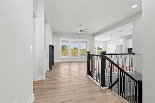 5005 146th St, Basehor, KS 66007 - hallway with an upstairs landing, light wood-style flooring, and recessed lighting