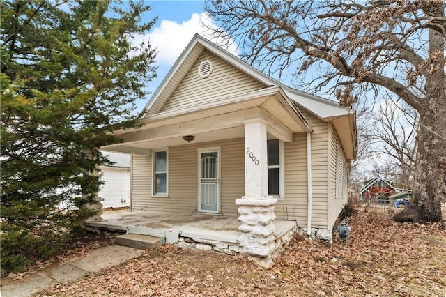 bungalow-style home with a garage and covered porch