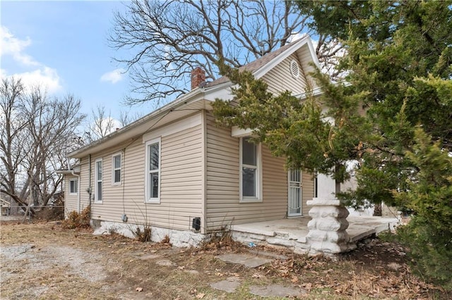 view of side of home with a patio