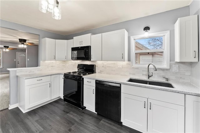 kitchen featuring white cabinetry, sink, and black appliances