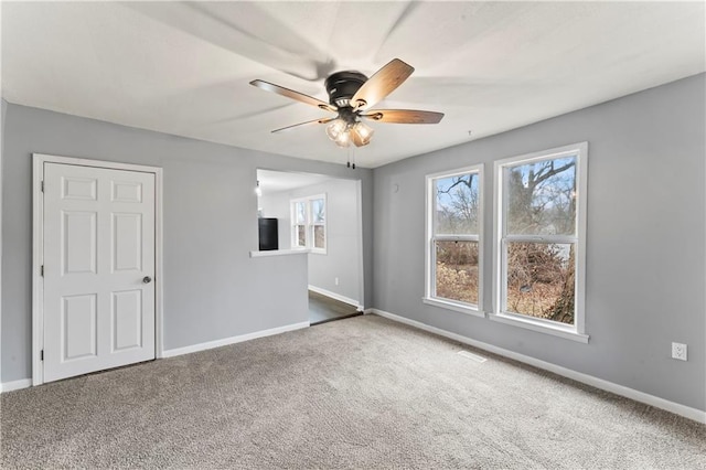 carpeted empty room with ceiling fan