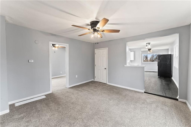 carpeted empty room featuring ceiling fan