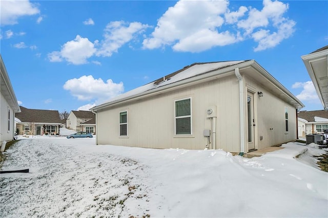 view of snow covered back of property