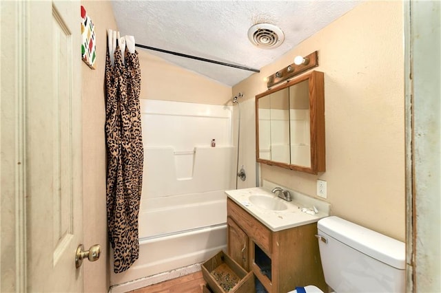 full bathroom featuring vaulted ceiling, vanity, toilet, shower / bath combo, and a textured ceiling