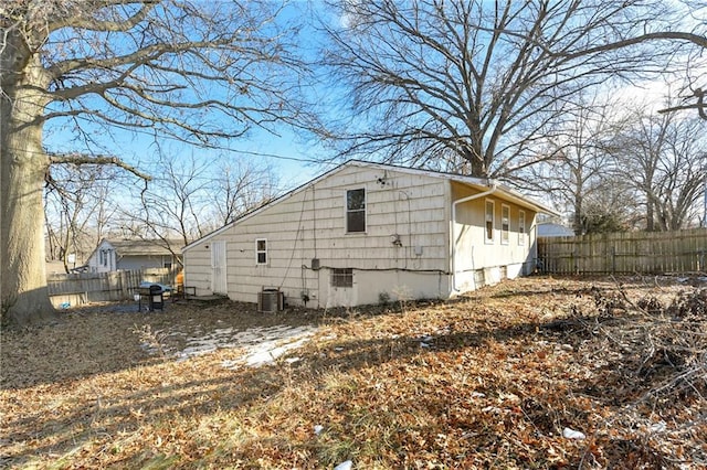 view of side of home featuring central AC