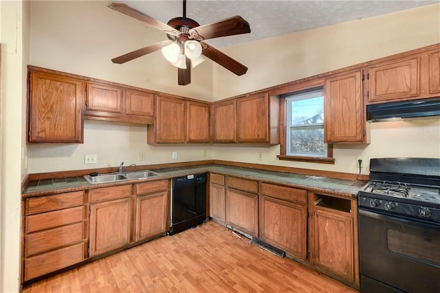 kitchen featuring sink, light hardwood / wood-style flooring, black appliances, and ceiling fan