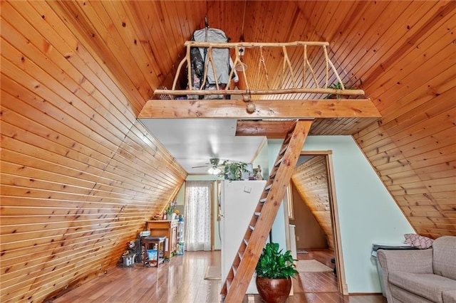 additional living space with wood walls, wooden ceiling, high vaulted ceiling, and hardwood / wood-style flooring