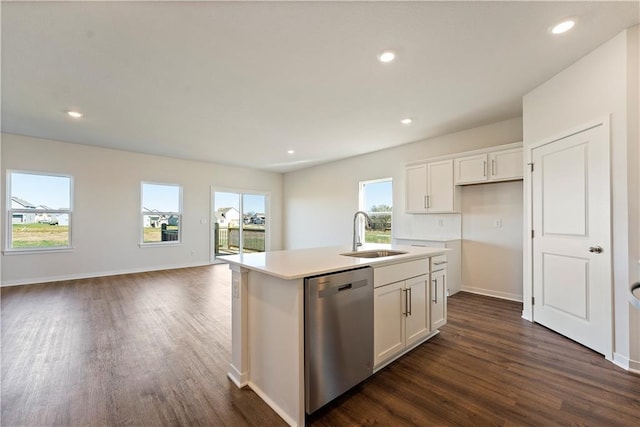 kitchen with white cabinetry, sink, stainless steel dishwasher, and a center island with sink