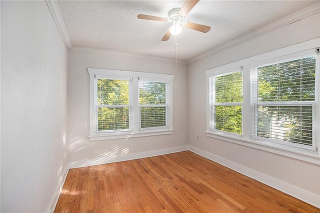 spare room with ceiling fan, wood-type flooring, ornamental molding, and a textured ceiling