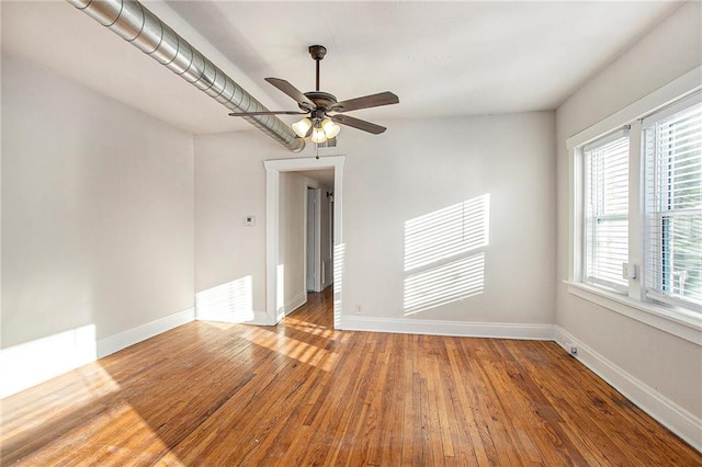 empty room featuring wood-type flooring and ceiling fan