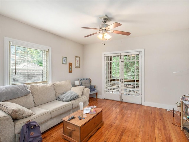 living room with ceiling fan, light hardwood / wood-style flooring, and french doors