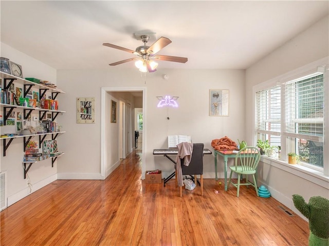 office area with ceiling fan, a healthy amount of sunlight, and light wood-type flooring