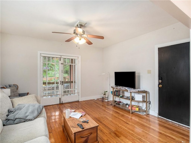 living room with hardwood / wood-style floors, french doors, and ceiling fan