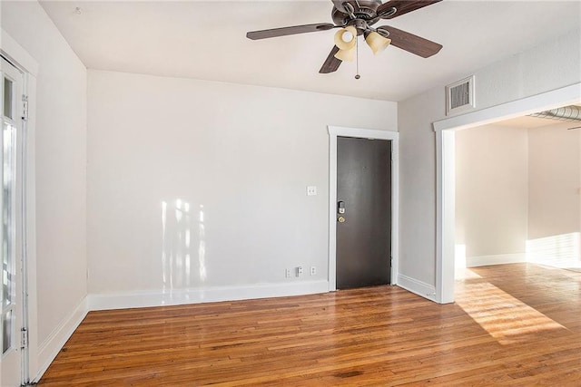 empty room featuring light hardwood / wood-style flooring and ceiling fan