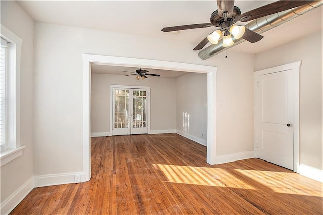 empty room with ceiling fan and hardwood / wood-style floors