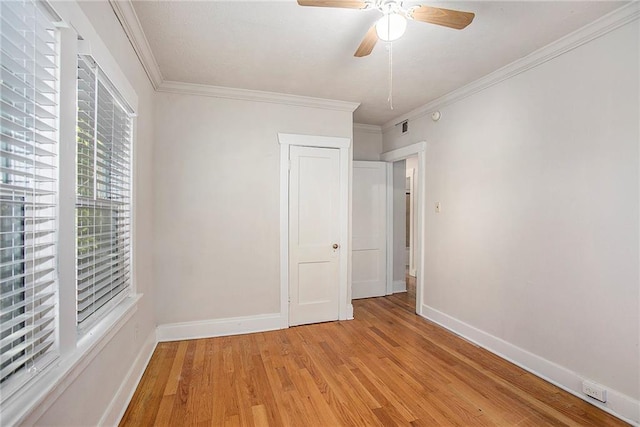 unfurnished bedroom with a closet, light hardwood / wood-style flooring, ceiling fan, and ornamental molding