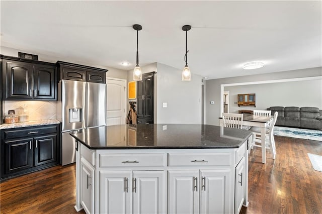 kitchen featuring stainless steel fridge with ice dispenser, dark wood-type flooring, white cabinets, and a kitchen island