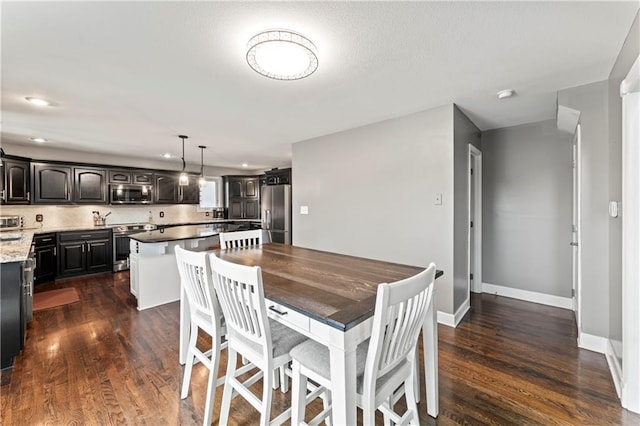 dining space featuring dark hardwood / wood-style floors