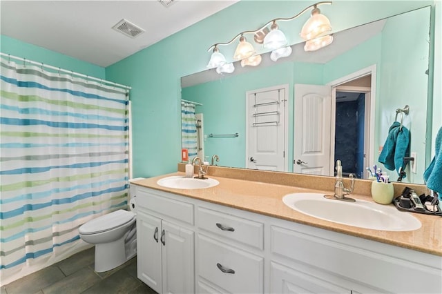 bathroom featuring vanity, tile patterned floors, and toilet